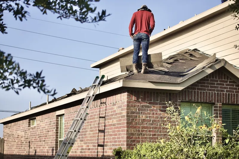Professional roofer working on a residential roof in Sweden